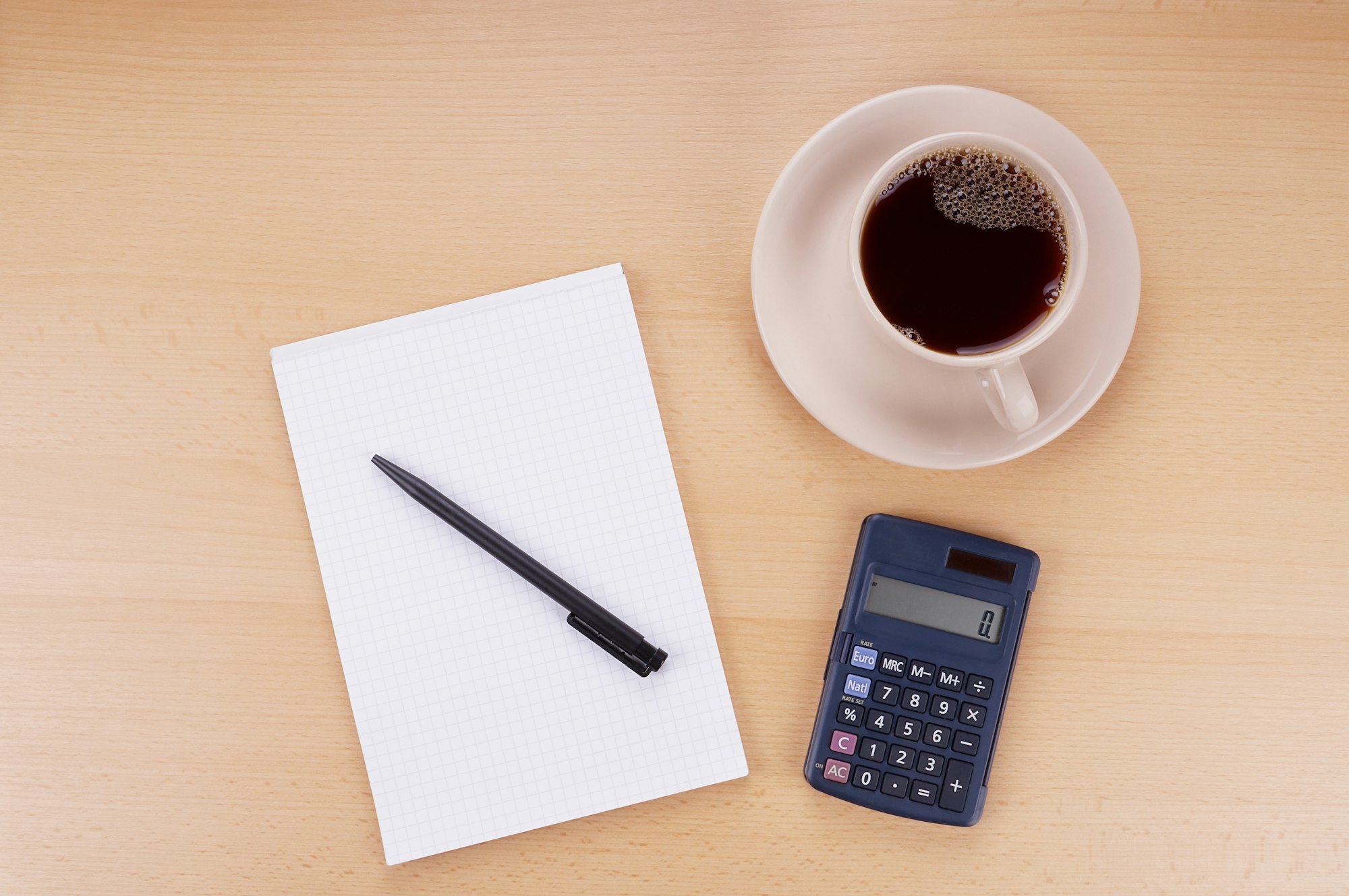 note pad calculator and coffee